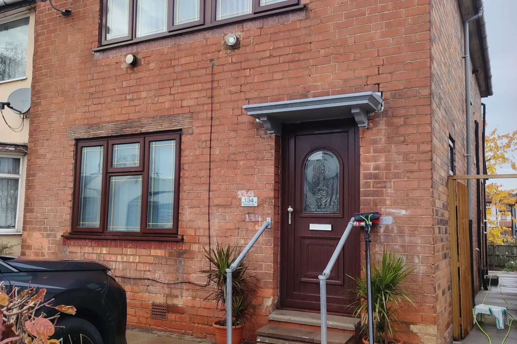 A brick house front door and window after cleaning, Window Cleaning in Birmingham