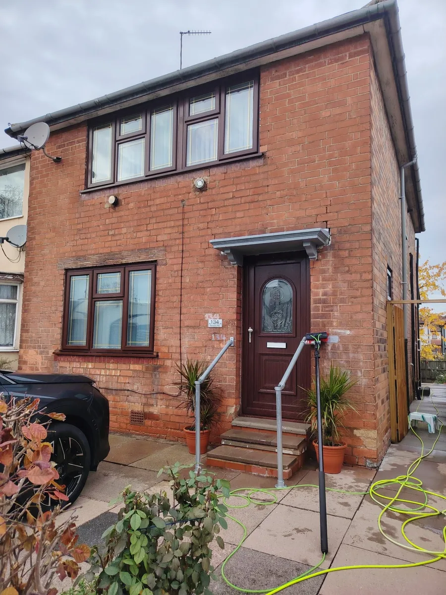 The paved front of a Birmingham semi, with the hose run out for the job