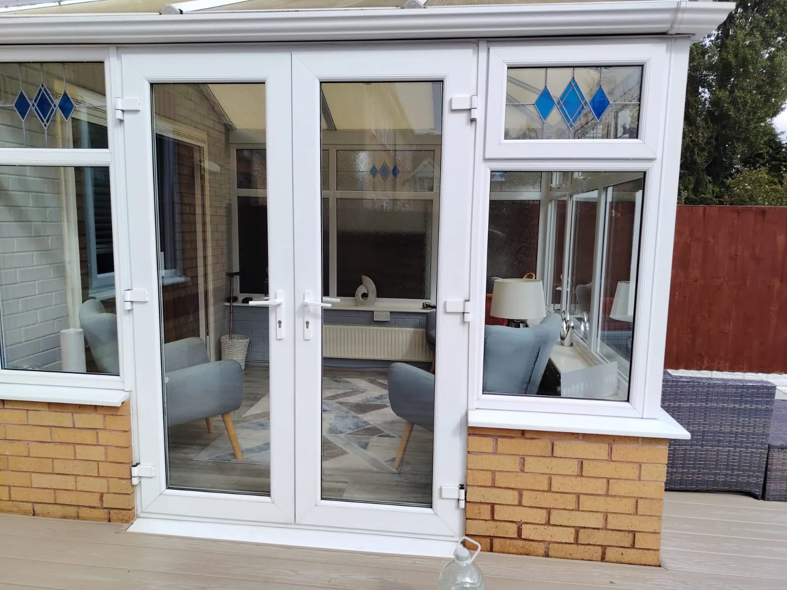 A white uPVC conservatory with its doors and side glazing cleaned, Conservatory Cleaning in Birmingham