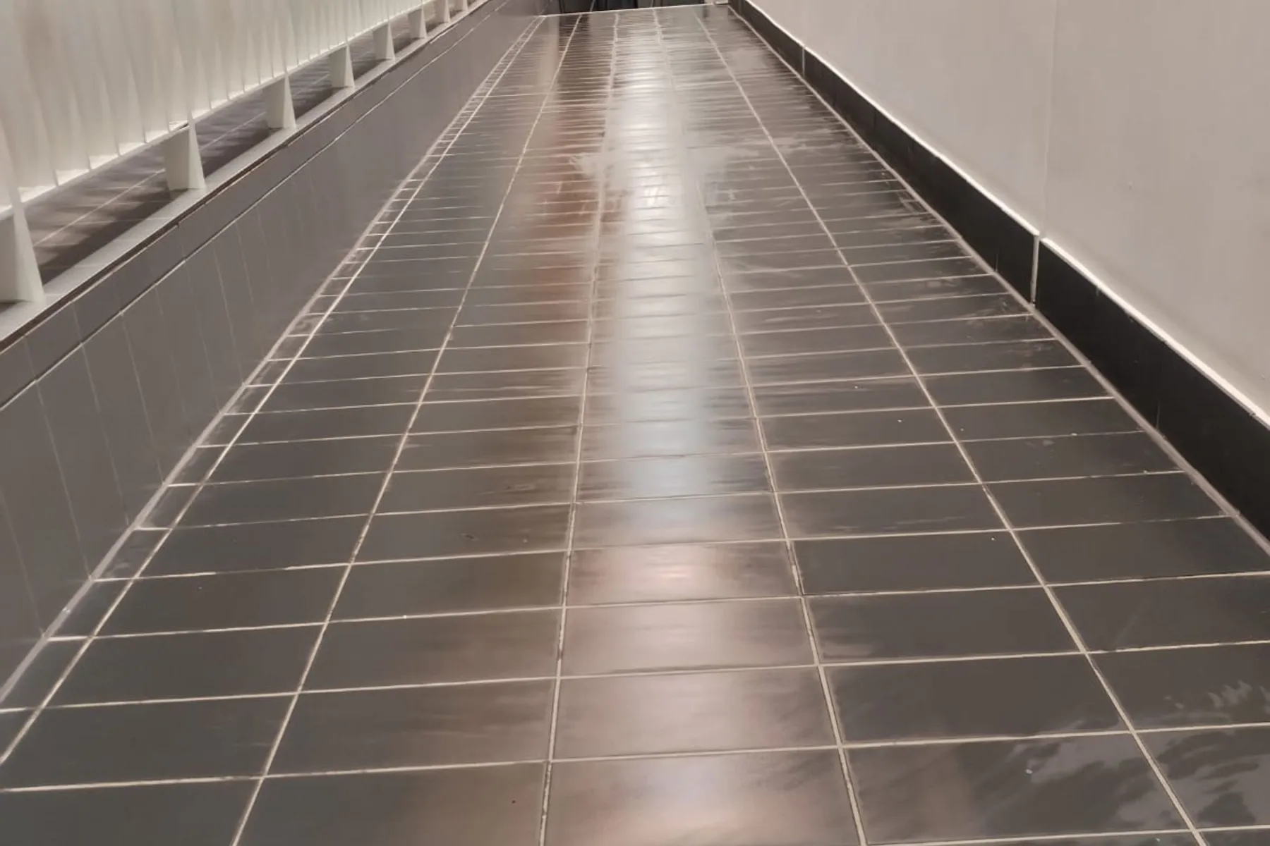 A long grey tiled floor cleaned end to end, Deep Cleaning in Birmingham