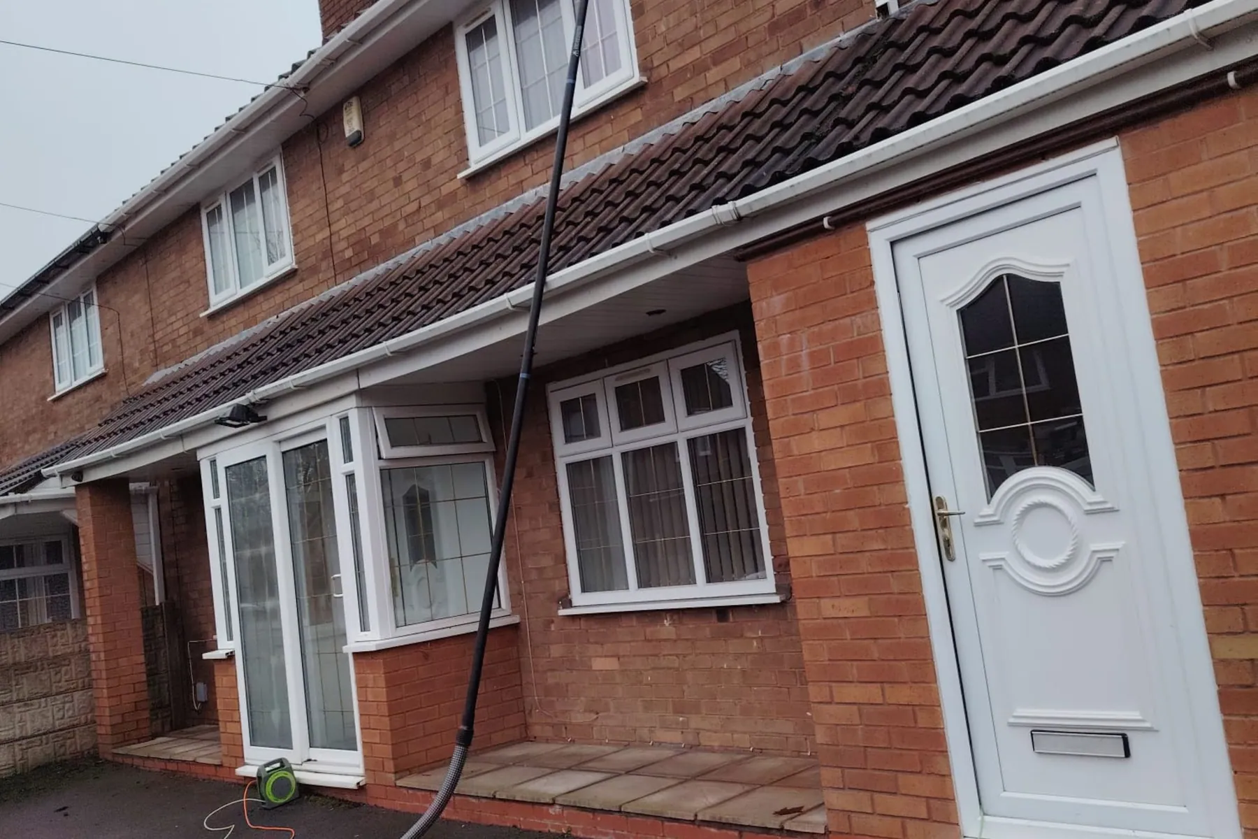 Window Cleaning in Birmingham, Pole work over the porch · Semi with white door