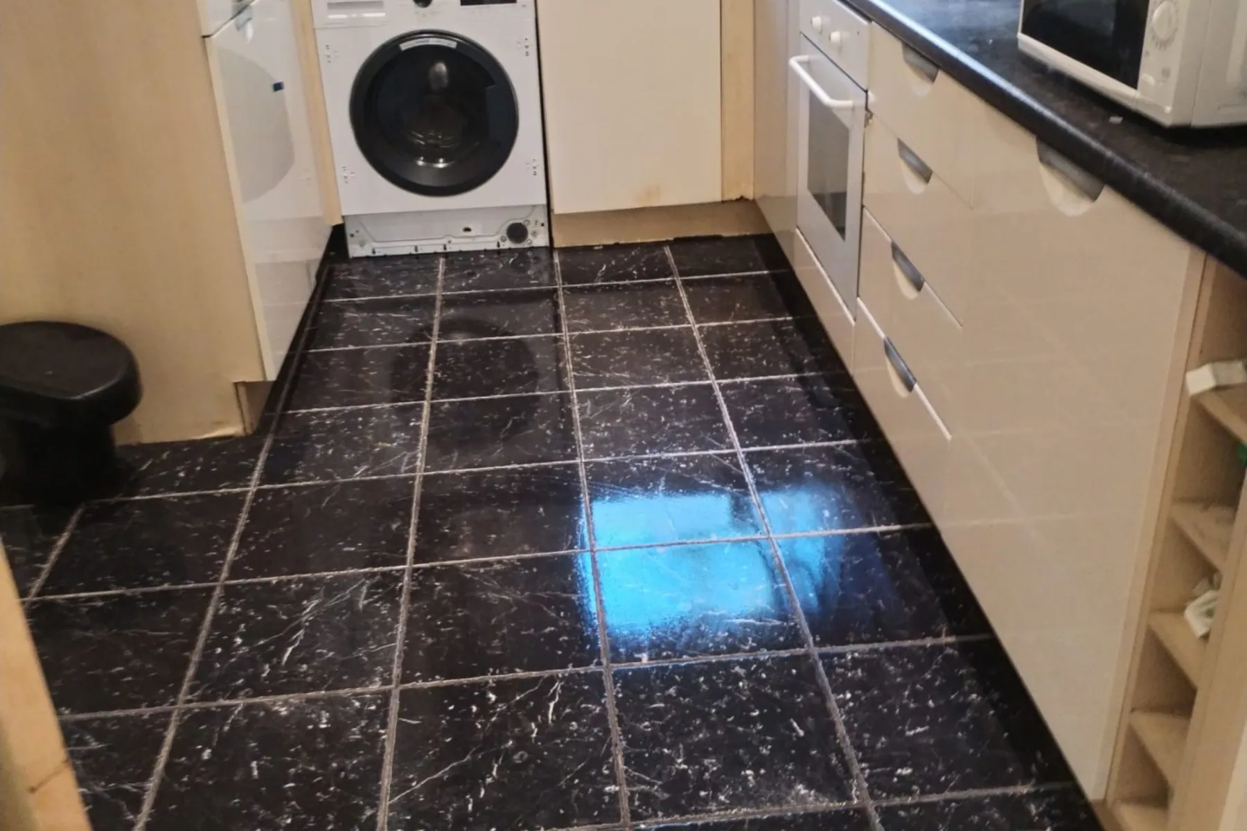 A black tiled kitchen floor cleaned to a shine, Deep Cleaning in Birmingham