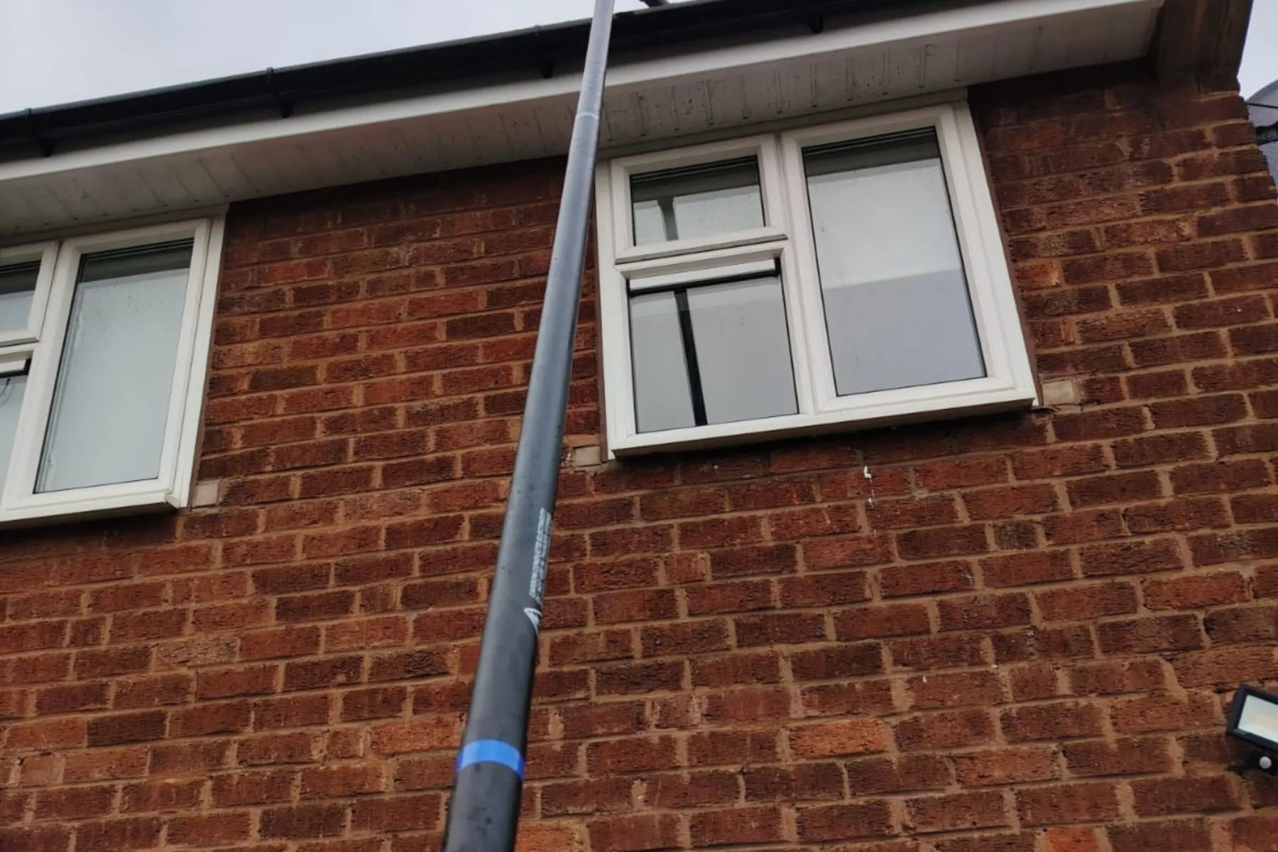 A water-fed pole reaching upstairs windows